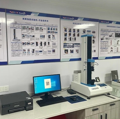 Professional lab scene with testing equipment, computer, and wall-mounted operation instruction posters.